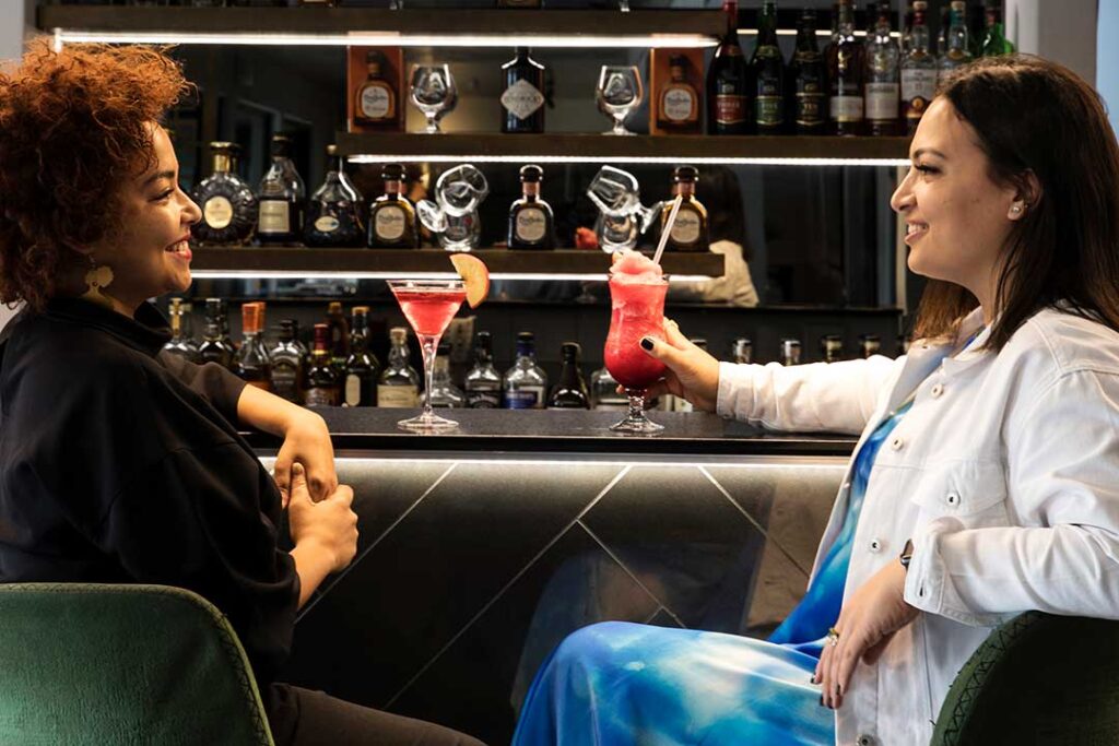 Women sitting in a bar drinking alcoholic beverages