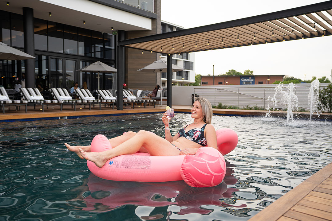 A lady in a pool in nelspruit at the capital mbombela hotel