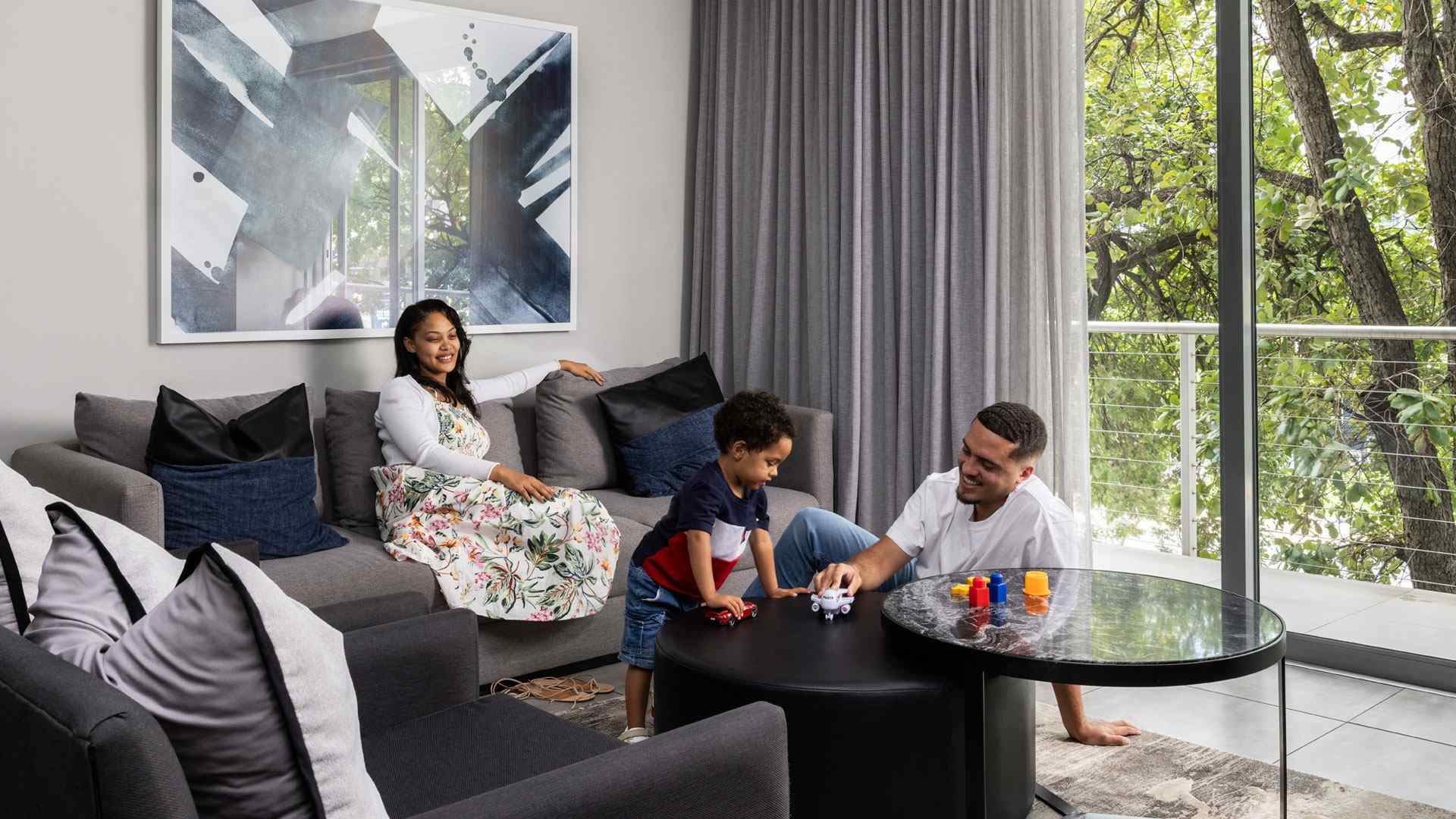 Family relaxing together in the lounge of a hotel apartment