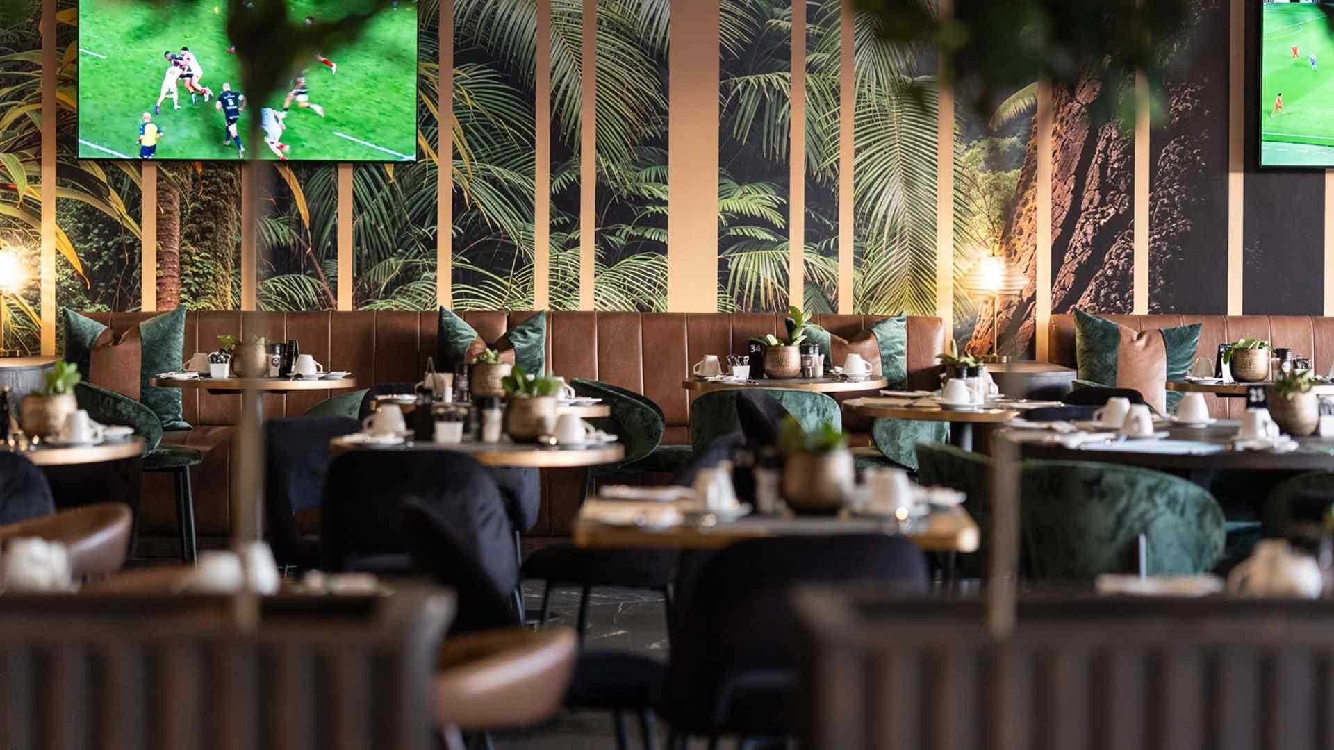 Restaurant dining room at The Capital Hotels with tables set for guests